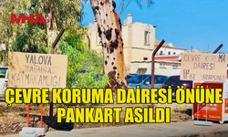 ÇEVRE KORUMA DAİRESİ ÖNÜNE PANKART ASILDI